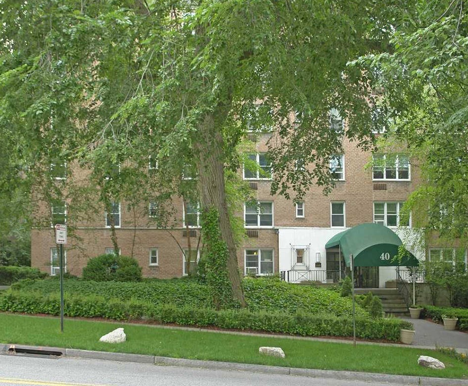 the front of a building at street level with trees