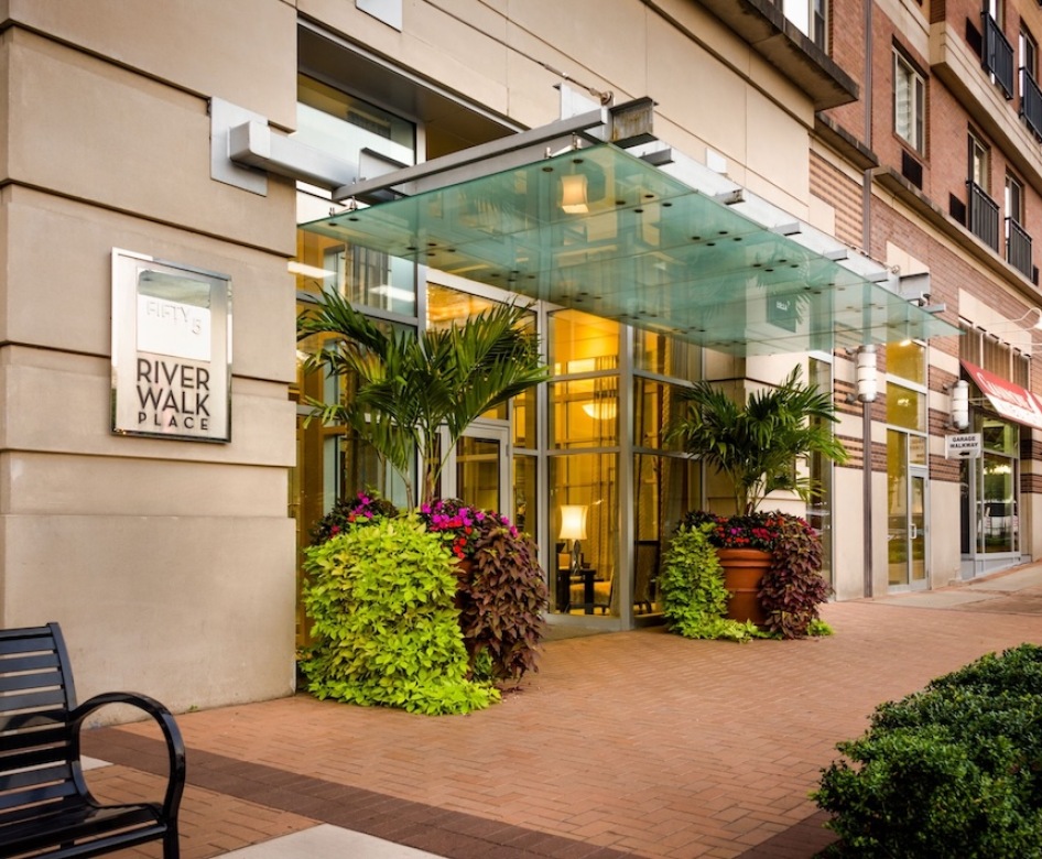 the front of a building at street level with shrubs