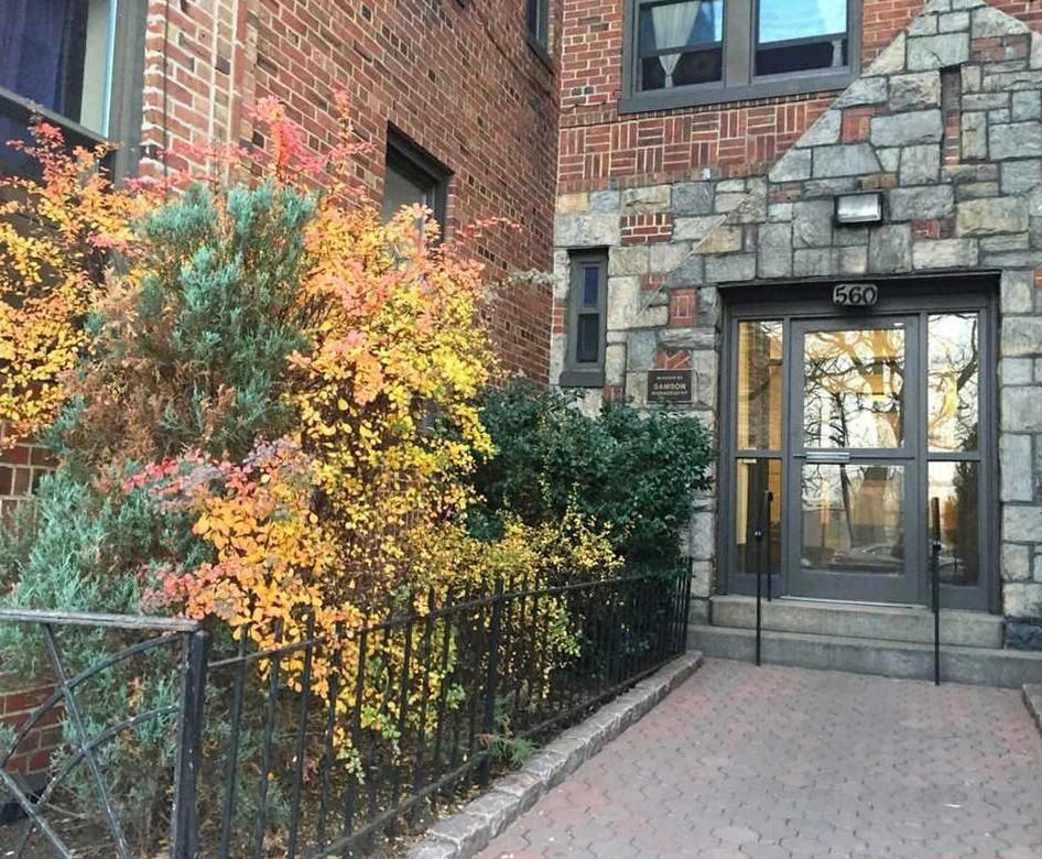 an entrance to a building with bushes