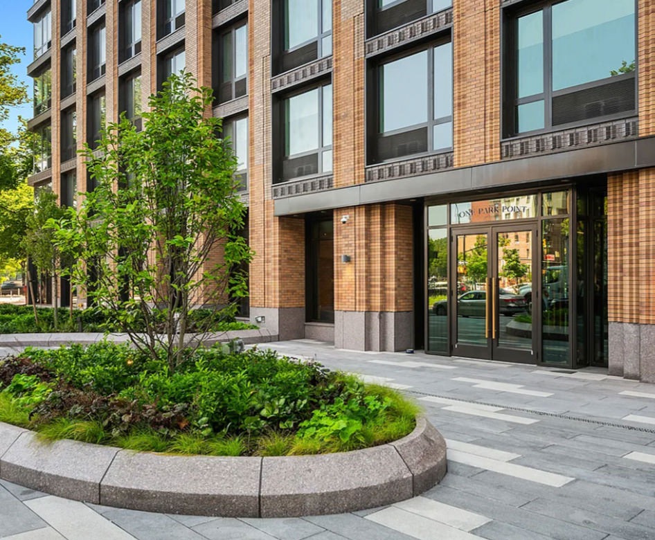 the front of a building at street level with trees